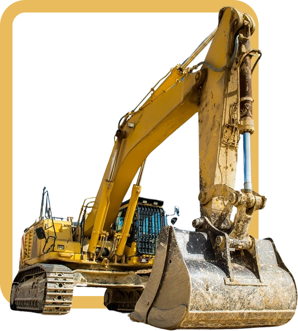 A yellow and black excavator is parked in front of a wall.